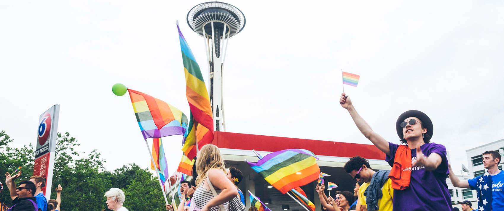 Pride Parade attendees with needle in the background